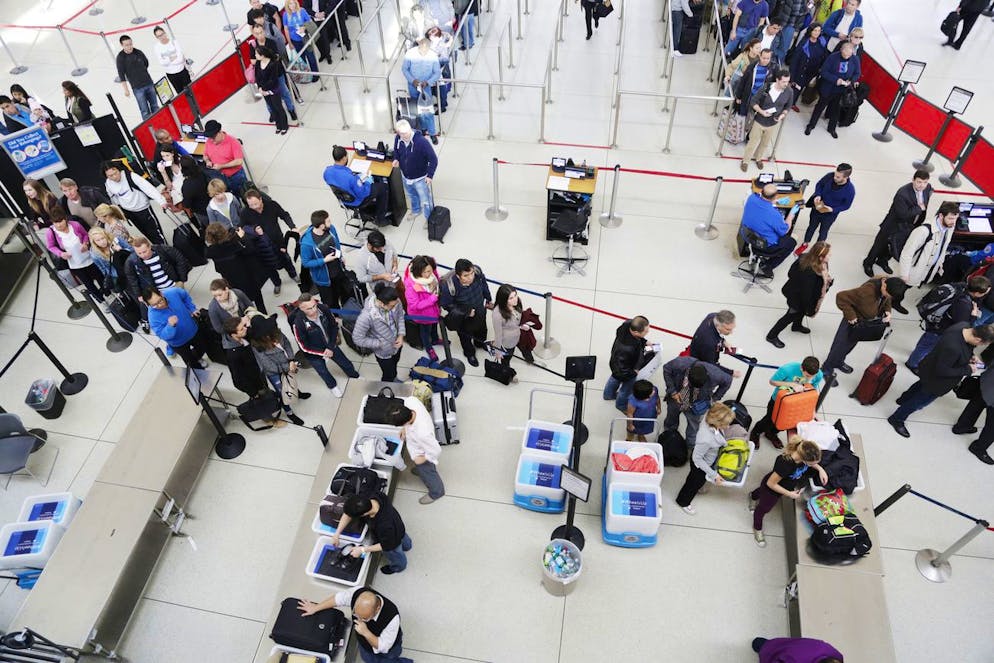 Passengers line up to pass through security before boarding flights at John F. Kennedy International Airport, Thursday, Oct. 30, 2014 in New York. (AP Photo/Mark Lennihan)