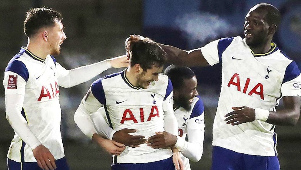 Tottenham Hotspur players celebrate after Tottenham's Harry Winks, centre, scored his side's second goal during the English FA Cup 4th round soccer match between Wycombe Wanderers and Tottenham Hotspur at Adams Park stadium in High Wycombe, England, Monday, Jan. 25, 2021. (AP Photo/Frank Augstein)