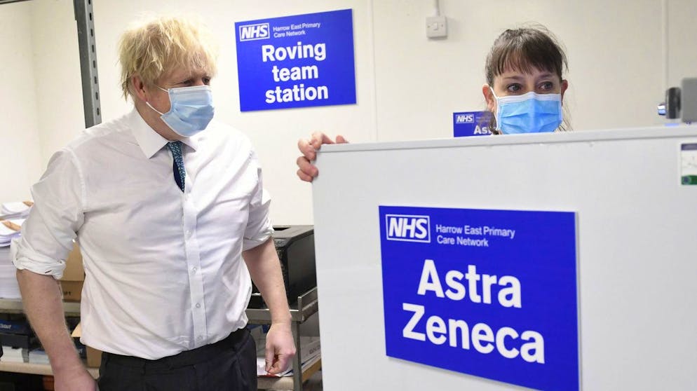 Britain's Prime Minister Boris Johnson, left, is shown the distribution operation for sending the Oxford Astrazeneca coronavirus vaccine out to local clinics, during a visit to Barnet FC's ground at the Hive, which is being used as a coronavirus vaccination centre, in London, Monday, Jan. 25, 2021. (Stefan Rousseau/Pool Photo via AP)