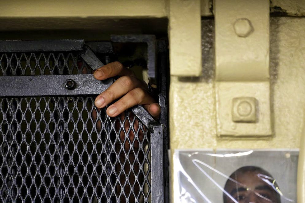 In this photo taken on Tuesday, Dec. 29, 2015, the fingers of Martin Navarette reach out of his cell on death row at San Quentin State Prison in San Quentin, Calif. With California's lethal injection protocol in limbo, the nearly 750 inmates at San Quentin State Prison, the nation's most populous death row, are more likely to die from natural causes or suicide than execution. The inmates await a final decision on a proposed one-drug execution method and the possibility that voters in 2016 will scrap the death penalty altogether. (AP Photo/Ben Margot)