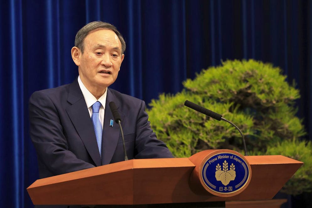 Japanese Prime Minister Yoshihide Suga holds a New Year's press conference at his official residence in Tokyo Monday, Jan. 4, 2021. Suga said Monday vaccine approval was being speeded up and border controls beefed up to curb the spread of the coronavirus, and he promised to consider declaring a state of emergency. (Yoshikazu Tsuno/Pool Photo via AP)