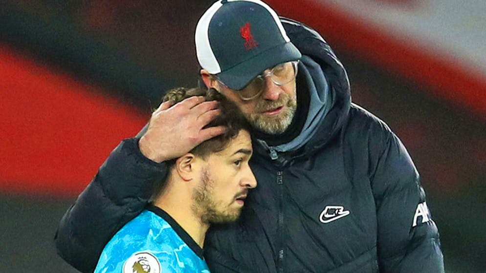 Liverpool's manager Jurgen Klopp, right, talks with substitute Xherdan Shaqiri as he prepares to join the game during the English Premier League soccer match between Southampton and Liverpool at St Mary's Stadium, Southampton, England, Monday, Jan. 4, 2021. (AP Photo/Adam Davy,Pool)