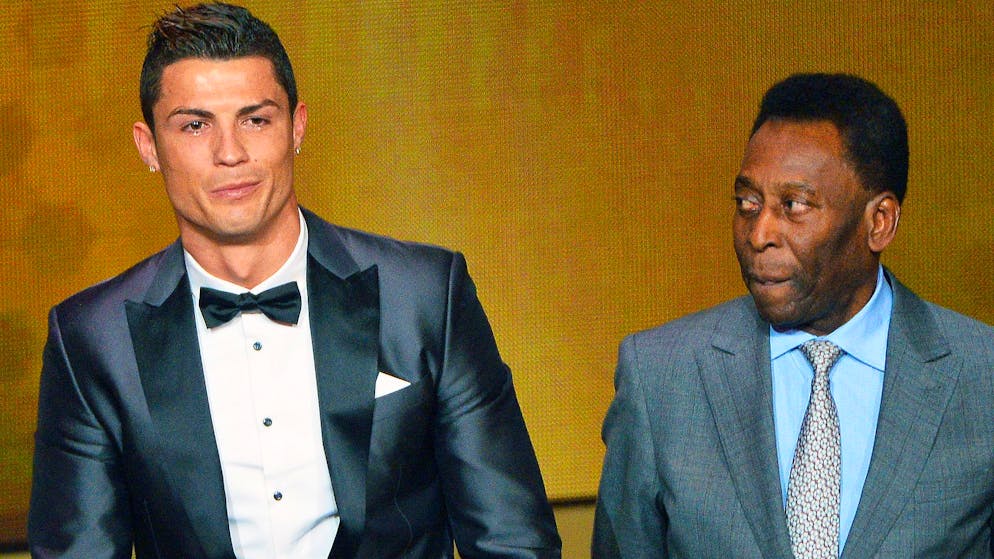Real Madrid's Portuguese forward Cristiano Ronaldo flanked by Brazilian football legend Pele (R) receives the FIFA Ballon d'Or 2013 trophy at the Kongresshalle on January 13, 2014 in Zurich, Switzerland. Photo By Justin Lorget (Photo by chesnot/Corbis via Getty Images)
