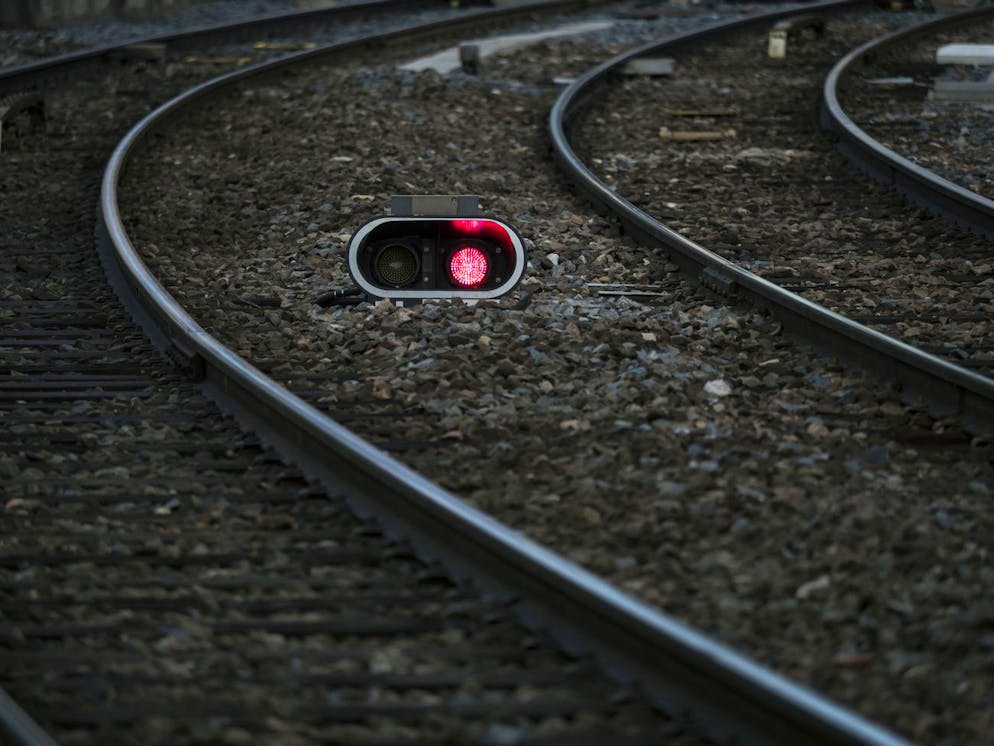 A red light is pictured between train tracks during a railway strike at the Lyon Perrache train station, central France, Tuesday, April 3, 2018. A major French railway strike brought the country's famed high-speed trains to a halt Tuesday, leaving passengers stranded or scrambling for other options _ and posing the biggest test so far for President Emmanuel Macron's economic strategy. (AP Photo/Laurent Cipriani)