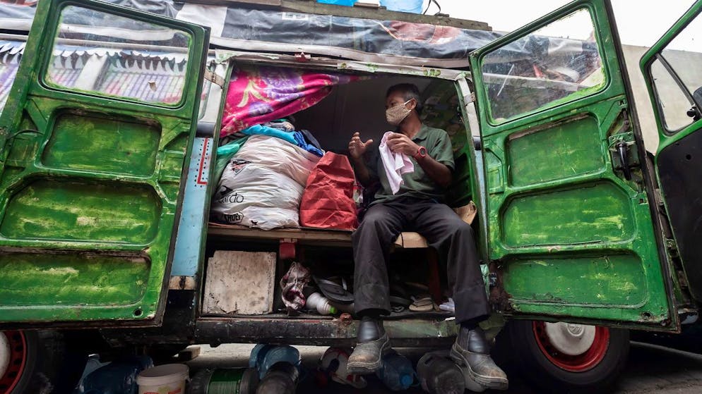 epa09189555 Geraldo Pereira, 60, lives in a van with his wife in a central street in Sao Paulo, Brazil, 07 May 2021 (issued 10 May 2021). A couple of vans, a school bus, and a motor home occupy a street near one of Sao Paulo's busiest subway stops. A couple of vans, a school bus, and a motor home occupy a street near one of Sao Paulo's busiest subway stops. Inside it live the Brazilian 'nomads', people who lost everything in the 2015 crisis and were forced to make their vehicles home. Who lives on wheels in Brazil moves between and through neighborhoods of the same city, always in search of a safe place where be able to do small jobs. EPA/Sebastiao Moreira