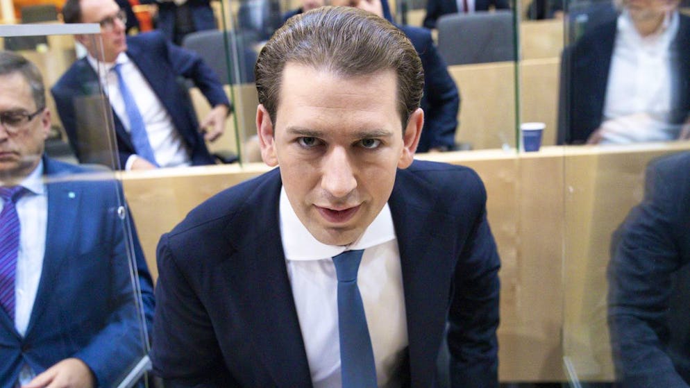 Sebastian Kurz, the former Austrian Chancellor, takes his seat for the sworn-in as deputy in the Austrian Parliament in Vienna, Austria, Thursday, Oct. 14, 2021. (AP Photo/Lisa Leutner)