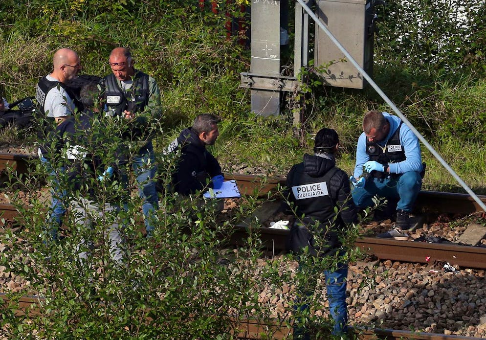 Police officers investigate after a train accident in Ciboure, near Saint Jean de Luz, southwestern France, Tuesday, Oct.12, 2021. A train hit and killed three people and seriously injured another person in southwestern France on Tuesday morning. A local mayor said the victims were thought to be migrants who were resting on the tracks. (AP Photo/Bob Edme)
