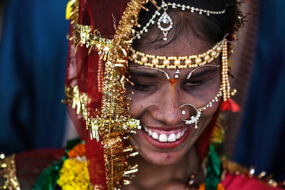 epa06629038 An Indian newlywed blind bride smiles after her wedding ceremony during a mass marriage for blind and handicapped people at Ulhasnagar in Thane, on the outskirts of Mumbai, India, 25 March 2018. Some 11 blind, partially blind and handicapped couples got married during the ceremony which was organized for the financially weaker strata of the society by the Blind's Welfare Association of Maharashtra. EPA/DIVYAKANT SOLANKI