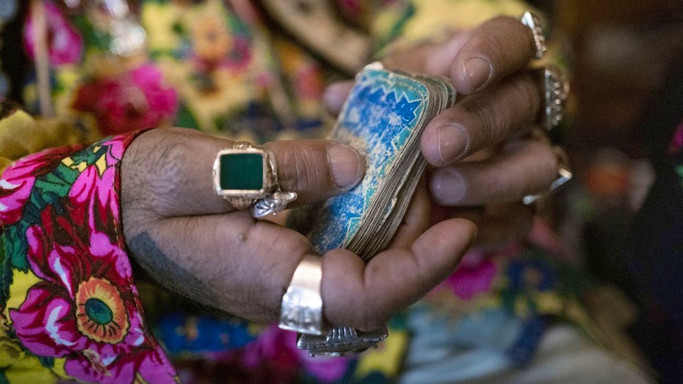 Zoltan Sztojka, traditional Gypsy fortune-teller holding his cards in his hand in Soltvadkert, central Hungary on Oct. 10, 2021. Sztojka, by his own account HungaryâÄ™s last Roma fortuneteller, is working to preserve his culture's traditions that are slowly vanishing in the Central European country. (AP Photo/Bela Szandelszky)