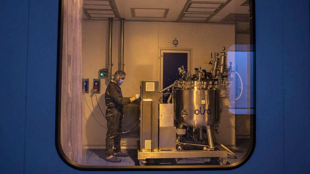 A lab technician works at the Eva Pharma facility in Cairo, Egypt, Sunday, July 12, 2020. Eva Pharma, a leading Egyptian pharmaceutical company is producing two drugs used in the treatment of COVID-19 patients -- remdesivir for severe cases in intensive care, and avipiravir indicated for moderate cases. (AP Photo/Nariman El-Mofty)