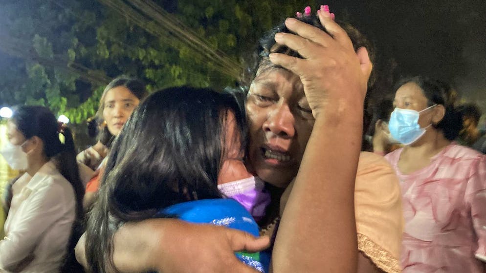 A mother reacts after her daughter, left, was released from Insein Prison in Yangon, Myanmar, Monday, Oct. 18, 2021. Myanmar's government on Monday announced an amnesty for more than 5,600 people arrested for taking part in anti-government activities that protested February's seizure of power by the military. Over 1,000 people were freed from prisons around the country and charges against more than 4,000 others were suspended. (AP Photo)