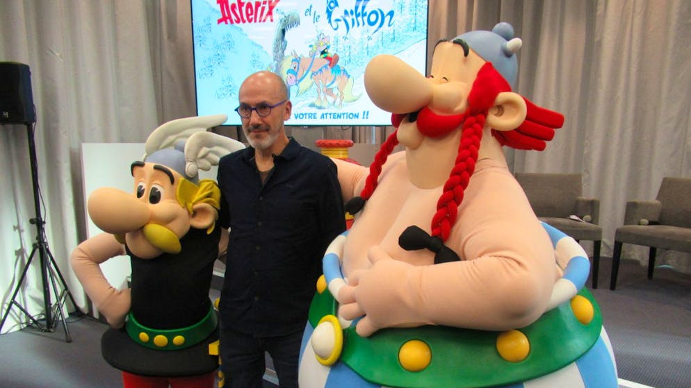 11 October 2021, France, Paris: Comic author Jean-Yves Ferri with Asterix and Obelix figures at the presentation of the new