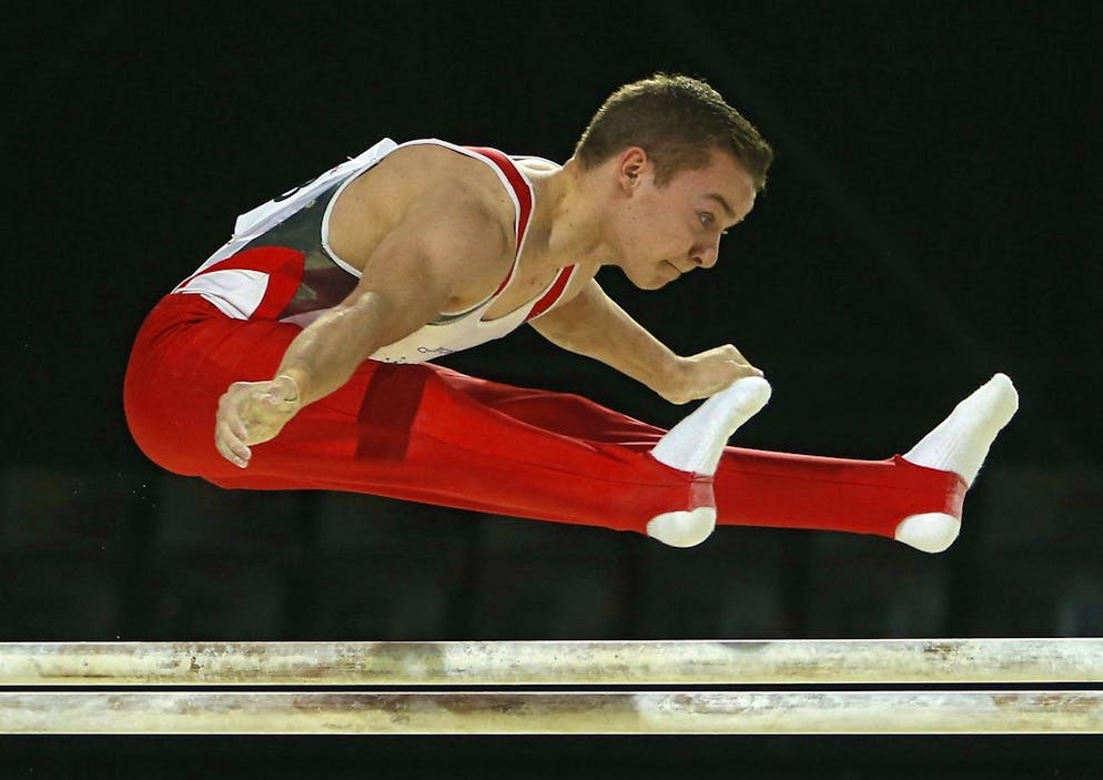 epa04712004 Swiss athlete Christian Baumann performs in the Men's Parallel bars final at the Men's European Artistic Gymnastic Championships in Montpellier, France, 19 April 2015. EPA/GUILLAUME HORCAJUELO