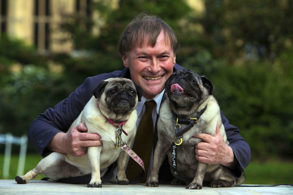 Conservative MP David Amess with his pugs, Lily and Boat at the Westminster Dog of the Year competition at Victoria Tower Gardens in London on Oct. 10, 2013. British police say a man has been arrested after a reported stabbing in eastern England. News outlets say the victim is Conservative lawmaker David Amess. The Essex Police force said officers were called to reports of a stabbing in Leigh-on-Sea just after noon Friday. It said âÄœa man was arrested shortly after & weâÄ™re not looking for anyone else.âÄ (Geoff Caddick/PA via AP)