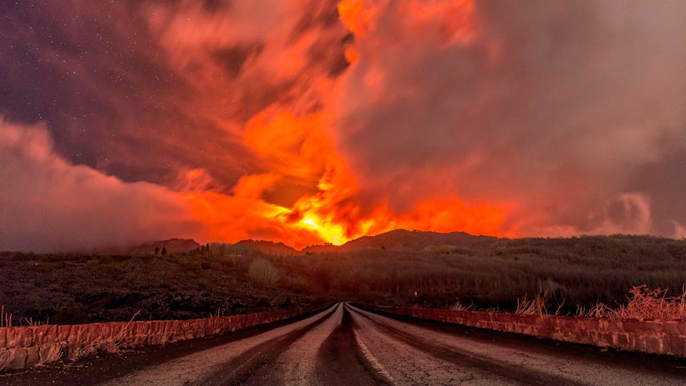 A glowing river of lava gushes from the slopes of Mt Etna, Europe's largest active volcano, near Zafferana Etnea, Sicily, early Wednesday, March 10, 2021. Today's activity is the 11th major eruption in the past few weeks. (AP Photo/Salvatore Allegra)