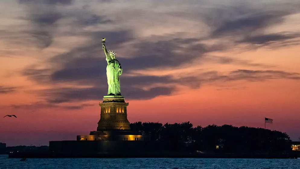 Fireball in the sky. Meteorite races over Statue of Liberty in New York