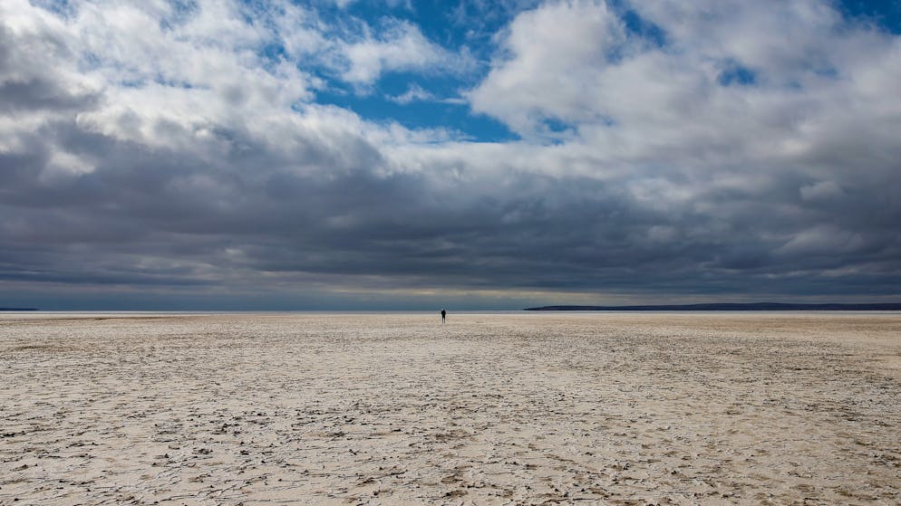 A man walks along Lake Tuz in Aksaray province, Turkey, Monday, Oct. 25, 2021. Lake Tuz, Turkey’s second largest lake, and home to several bird species has seen its waters entirely recede this year, a victim of climate change-induced drought that has hit the region as well as decades-long wrongful agricultural policies that have exhausted the lake’s underground waters. (AP Photo/Emrah Gurel)
