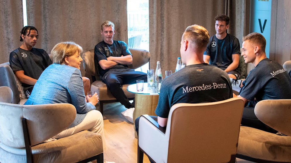 EPPAN, ITALY - JUNE 03: In this handout photo provided by the German Government Press Office (BPA), German Chancellor Angela Merkel talks to Leroy Sane, Julian Brandt, Marc-Andre ter Stegen, Leon Goretzka, Joshua Kimmich und Jonas Hector of Germany during her visit at the Southern Tyrol Training Camp on day twelve on June 3, 2018 in Eppan, Italy. (Photo by Guido Bergmann/Bundesregierung via Getty Images)