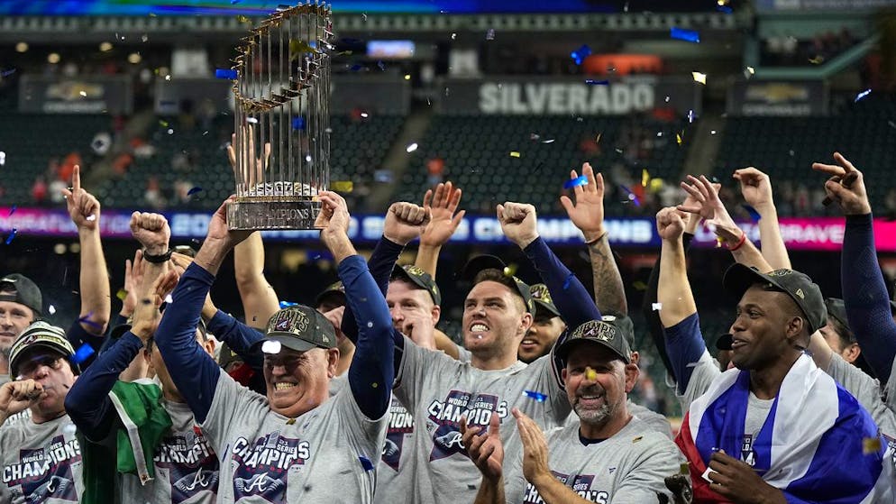 Atlanta Braves manager Brian Snitker holds up the trophy = after winning baseball's World Series in Game 6 against the Houston Astros Tuesday, Nov. 2, 2021, in Houston. The Braves won 7-0. (AP Photo/David J. Phillip)