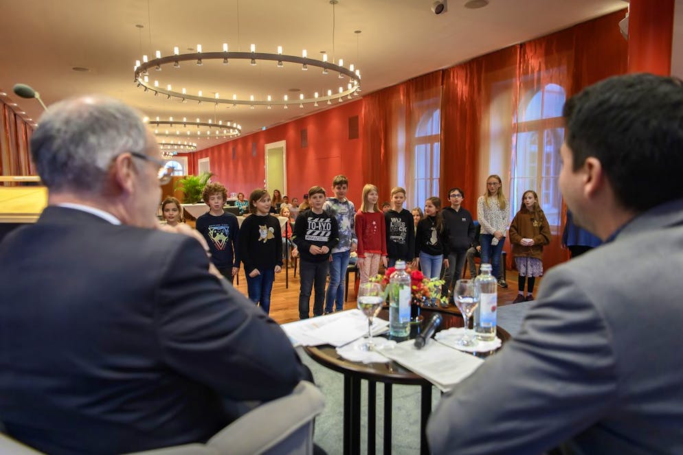 Federal President Guy Formelin, left, National Councilor Fabian Molina, SP-ZH, right, receives a Baselbieter and Zuercher school class on Friday, November 12, 2021 in Bernerhoff, participating in the SWISSAID badge sale.  In Bern.  (Keystone / Anthony Annex)