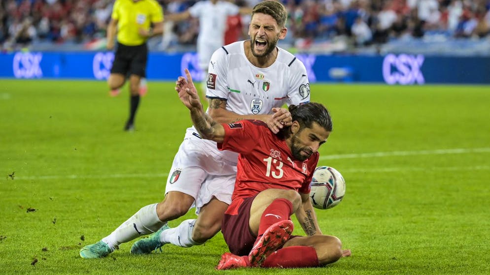 Italy's Domenico Berardi, left, is fouled by Switzerland's Ricardo Rodriguez, action sanctioned with a penalty, during the 2022 FIFA World Cup European Qualifying Group C soccer match between Switzerland and Italy at the St. Jakob-Park stadium in Basel, Switzerland, on Sunday, September 5, 2021. (KEYSTONE/Georgios Kefalas)