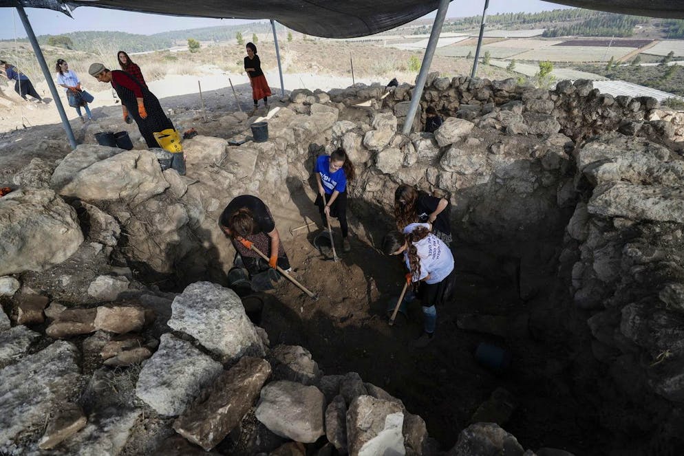 epa09584944 Israeli employees and volunteers of the Israel Antiquities Authority dig at Hellenistic fortified structure destroyed and burned by Hasmoneans uncovered during Israel Antiquities Authority excavations in Lachish Forest, in the Judean Shephelah, 16 November 2021. The building's devastation is probably related to the region's conquest by the Hasmonean leader John Hyrcanus in around 112 BCE, according to Israeli Antiquities Authority archaeologists directing the excavation. The external walls, no less than three meters wide, were built of large stones and had a sloping outer glacis to prevent the wall from being scaled. The inside of the structure was divided into seven rooms, preserved to an exceptional height of roughly two meters. The excavation uncovered a stairwell leading to a second floor, which was not preserved. The building is estimated to have been about five-meter high. EPA/ATEF SAFADI
