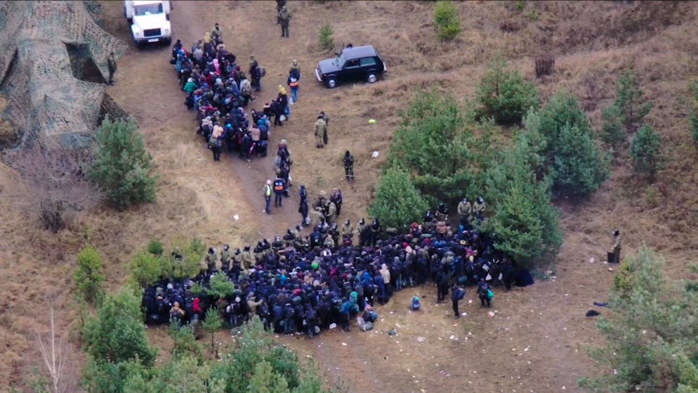 epa09590053 A handout photo made available by Polish Border guard shows an aerial view from the Polish side on migrants at a camp near the Polish-Belarusian border crossing in Kuznica Bialostocka-Bruzgi, Belarus, 18 November 2021. The Belarusian services directed foreigners to a transport and logistics center several hundred meters away. Poland has been struggling to stem the flow of asylum-seekers, refugees and migrants crossing into the country from Belarus. The Polish government says the migrants have been invited to Belarus by the Belarusian president, allegedly under the promise they will be able to live in the EU. EPA/POLISH BORDER GUARD / HANDOUT POLAND OUT HANDOUT EDITORIAL USE ONLY/NO SALES