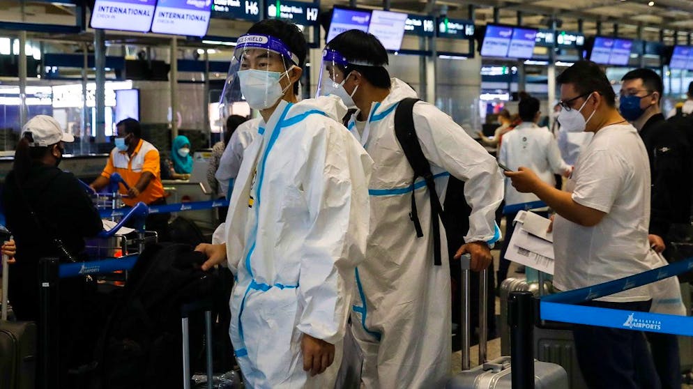 epa09610550 Travelers wearing personal protective equipment (PPE) wait for their turn at a flight ticket counter at Kuala Lumpur International Airport in Sepang, Malaysia, 29 November 2021. The Omicron variant of SARS-CoV-2, the virus that causes COVID-19, was first reported to the World Health Organisation (WHO) from South Africa on 24 November 2021. The WHO designated it as a variant of concern (VOC). Several countries around the wold are gradually reinstating tough border restrictions in a bid to stem the spread of the 'heavily mutated' variant. EPA/FAZRY ISMAIL