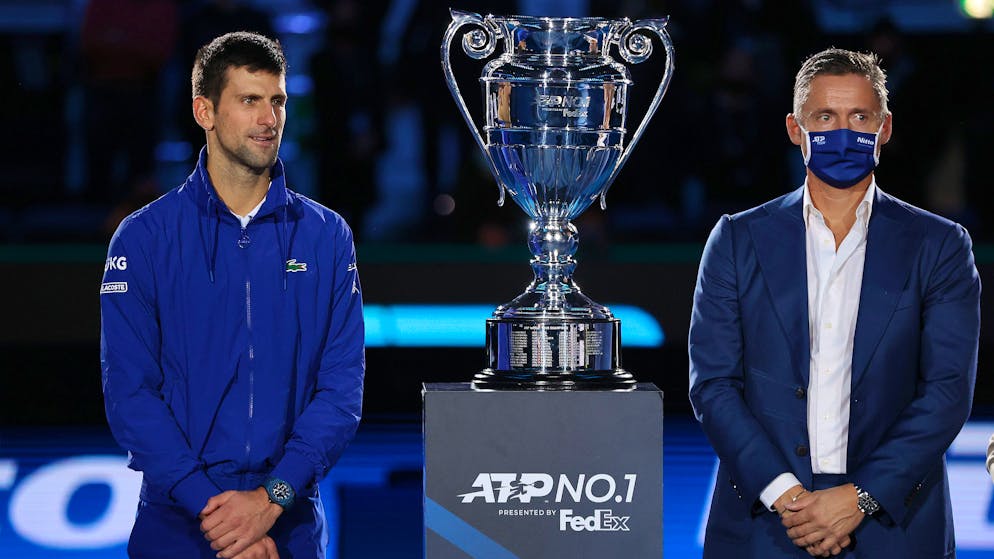 Novak Djokovic of Serbia looks on with Andrea Gaudenzi