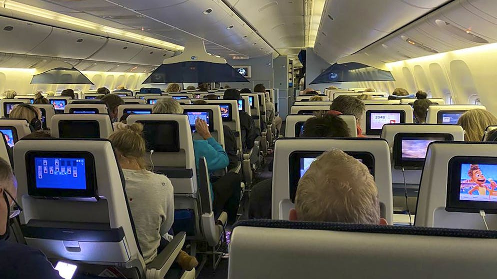 Passengers sit in their seats aboard KLM Flight 598 on the tarmac at Schipol airport in Amsterdam after it landed from Cape Town, South Africa on Friday Nov. 26, 2021. The flight was held on the edge of the runway at Schiphol airport for four hours pending special testing because of the new variant Advisers to the World Health Organization are holding a special session Friday to flesh out information about a worrying new variant of the coronavirus that has emerged in South Africa, though its impact on COVID-19 vaccines may not be known for weeks. (UGC via AP)
