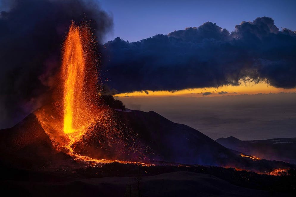 Lava flows from a volcano as seismic activity increases in recent days in the area on the Canary island of La Palma, Spain, Thursday, Dec. 2, 2021. Spain's National Geographic Institute registered 341 earthquakes over the past 24 hours. (AP Photo/Emilio Morenatti)