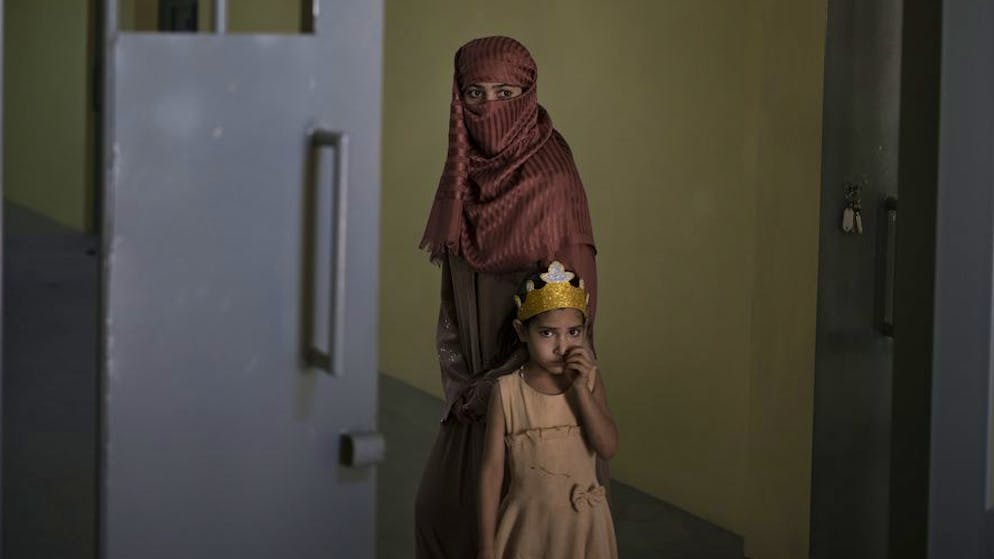 Razia and her 6-year-old daughter Alia, stand inside the women's section of the Pul-e-Charkhi prison in Kabul, Afghanistan, Thursday, Sept. 23, 2021. When the Taliban took control of a northern Afghan city of Pul-e-Kumri the operator of the only women's shelter ran away, abandoning 20 women in it. When the Taliban arrived at the shelter the women were given two choices: Return to their abusive families, or go with the Taliban, With nowhere to put the women, the Taliban took them to the abandoned women's section of Afghanistan's notorious Pul-e-Charkhi prison.