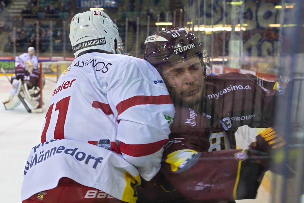 Lakers' defender Fabian Maier, left, body-checks Geneve-Servette's defender Sandy Smons, right, during a National League regular season game of the Swiss Championship between Geneve-Servette HC and RC Rapperswil-Jona Lakers, at the ice stadium Les Vernets, in Geneva, Switzerland, Friday, December 3, 2021. (KEYSTONE/Salvatore Di Nolfi)