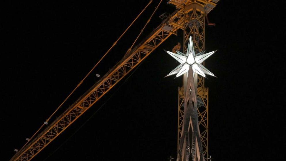 The new star atop the Sagrada Familia basilica's tower of Virgin Mary shines during the inauguration of the temple's second-highest tower, on December 8, 2021 in Barcelona. - The second-highest tower, which is 138 metres tall and dedicated to the Virgin Mary, was officially inaugurated today with the illumination of the gigantic 5.5-tonne star crowning its highest point. It is the tallest of the nine completed towers and the first to be inaugurated since 1976. (Photo by LLUIS GENE / AFP) (Photo by LLUIS GENE/AFP via Getty Images)