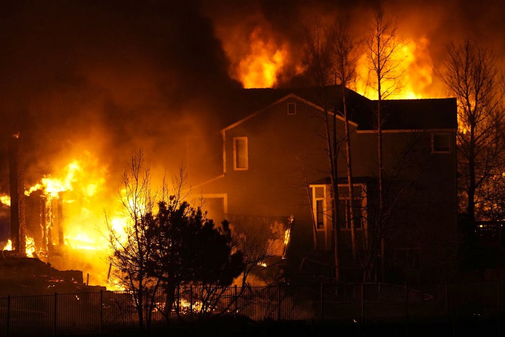 Homes burn as wildfires rip through a development Thursday, Dec. 30, 2021, in Superior, Colo. (AP Photo/David Zalubowski)