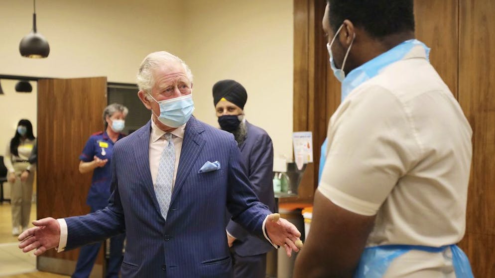 Britain's Prince Charles talks with a member of staff during a visit to the Queen Elizabeth Hospital in Birmingham, England, Wednesday Feb. 17, 2021, to thank volunteers undertaking clinical trials for the COVID-19 vaccinations. (Molly Darlington/Pool via AP)