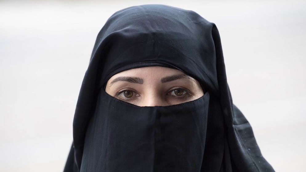 Karima im Niqab, unterwegs mit dem algerischen Polit-Aktivisten Rachid Nekkaz (nicht im Bild), demonstriert gegen das Burka-Verbot im Kanton St. Gallen, am Mittwoch, 3. Oktober 2018, in St. Gallen. Nekkaz sagt, er wolle der Bevoelkerung die Angst vor dem weiblichen Islam nehmen und die Bussen von verschleierten Frauen uebernehmen. Nekkaz beschreibt sich selbst als Gegner der Verschleierung, er wolle den Frauen aber die Freiheit dazu lassen. In St. Gallen bewarb er ausserdem sein Buch