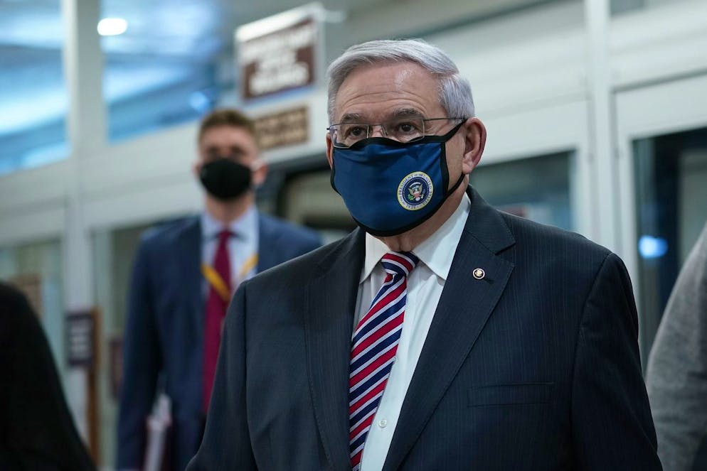 Sen. Bob Menendez, D-N.J., walks on Capitol Hill in Washington, Thursday, Feb. 11, 2021, before the start of the third day of the second impeachment trial of former President Donald Trump. (AP Photo/Susan Walsh)
