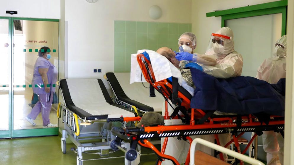 Medical workers attend to a covid-19 patient at a hospital overrun by the covid pandemic in Cheb, Czech Republic, Friday, Feb. 12, 2021. The Czech government has imposed a complete lockdown of the three hardest-hit counties to help contain the spread of a highly contagious variant of the coronavirus. The meeasures will became effective Friday for the two counties in western Czech Republic on the German border Cheb and Sokolov and another county in the northern part of the country Trutnov located on the border with Poland. (AP Photo/Petr David Josek)