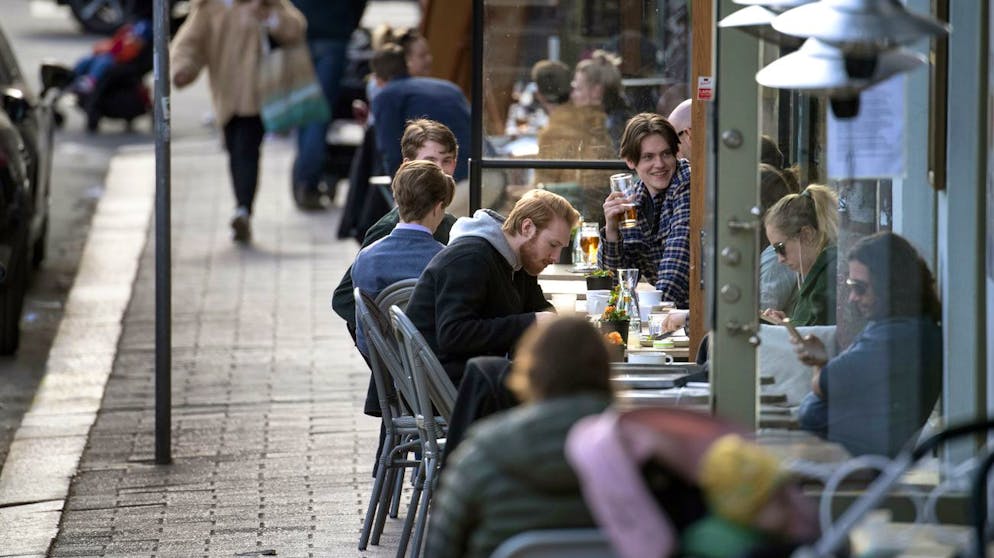 People enjoy themselves at an outdoor restaurant, amid the coronavirus outbreak, in central Stockholm, Sweden, Monday April 20, 2020. (Anders Wiklund/TT News Agency via AP)