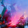 Supporters of Italian ski racer Massimiliano Blardone hold flares and the Italian national flag in the finish area stands during the the Men's Giant Slalom at the World Alpine Ski Championships in Bormio, Italy, Thursday Feb. 10, 2005. (KEYSTONE/AP Photo/Kevin Frayer)