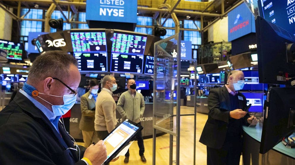In this photo provided by the New York Stock Exchange, traders gather at a post on the floor, Thursday, Feb. 4, 2021. Stocks moved higher in afternoon trading on Thursday, helped by strong company earnings as well as optimism that Washington can reach a deal for another round of fiscal stimulus for the millions of Americans who need it. (Colin Ziemer/New York Stock Exchange via AP)