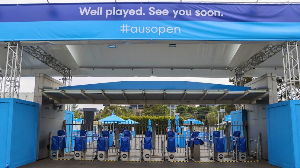 The locked gates at Melbourne Park, venue for the Australian Open tennis championships in Melbourne, Australia, Thursday, Feb. 4, 2021. All competition at six Australian Open tuneup events scheduled for Thursday was called off after a worker at one of the tournaments' Melbourne quarantine hotels tested positive for COVID-19.(AP Photo/Hamish Blair)