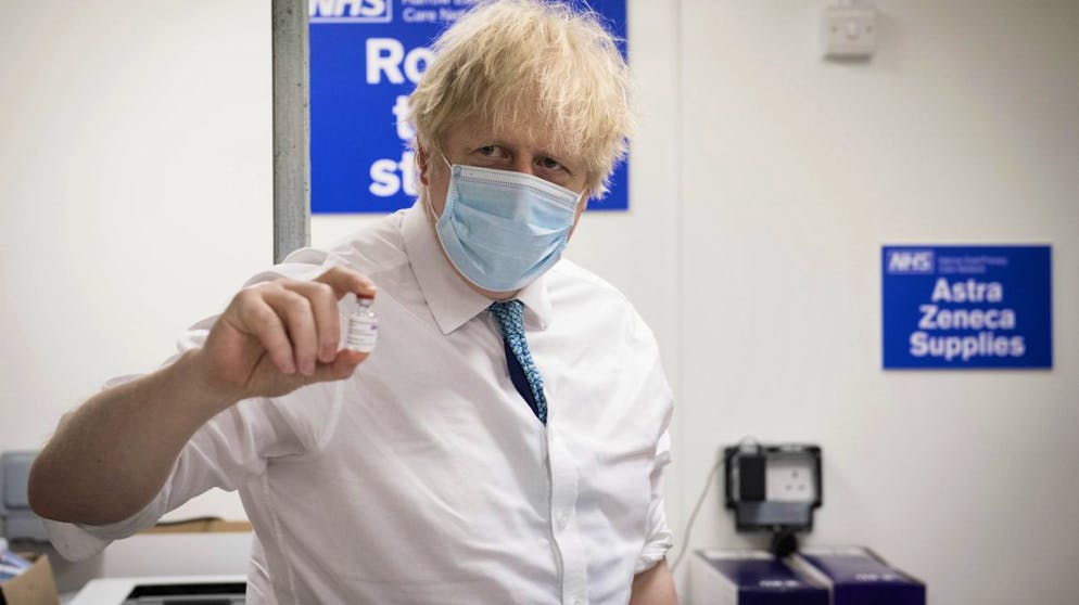 FILE - In this Monday, Jan. 25, 2021 file photo, Britain's Prime Minister Boris Johnson holds a vial of the Oxford AstraZeneca COVID-19 vaccine, during a visit to Barnet FC's ground at the Hive, which is being used as a coronavirus vaccination centre, in London. The European UnionâÄ™s dispute with AstraZeneca has intensified with the Anglo-Swedish drugmaker denying the EUâÄ™s assertion that it had pulled out of talks on vaccine supplies. AstraZeneca said that it still planned to meet with EU officials in Brussels later in the day.  The talks will be the third in as many days. AstraZeneca says the figures in its contract with the EU were targets that couldnâÄ™t be met because of problems in rapidly expanding production capacity. (Stefan Rousseau/Pool Photo via AP, File)