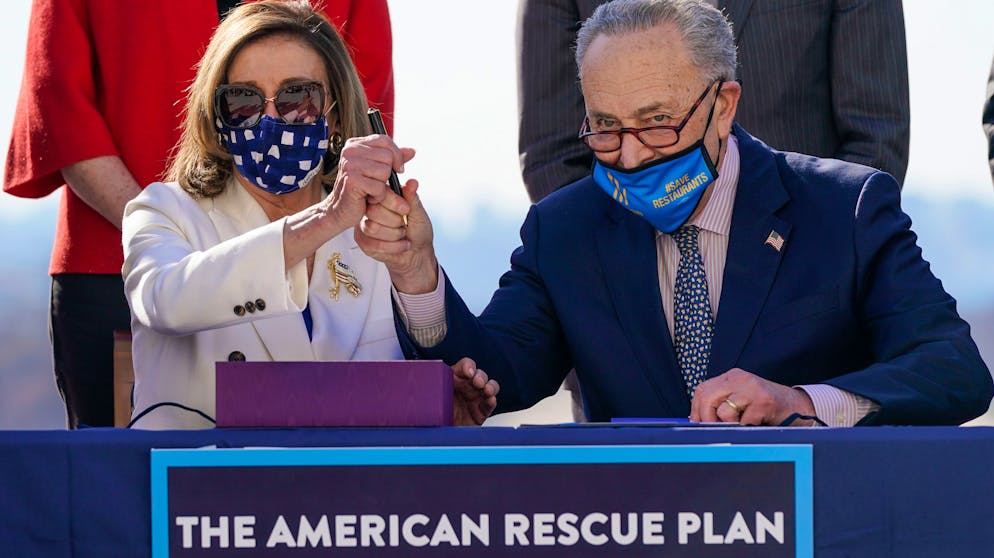WASHINGTON, DC - MARCH 10: Surrounded by Democratic House and Senate Committee Chairs, Speaker of the House Nancy Pelosi (D-CA) and Senate Majority Leader Chuck Schumer (D-NY) sign the $1.9 trillion COVID-19 relief bill during a bill enrollment ceremony on the West Front of the U.S. Capitol on March 10, 2021 in Washington, DC. President Joe Biden aims to sign the legislation in time to meet a Sunday deadline to renew unemployment aid programs. (Photo by Drew Angerer/Getty Images)