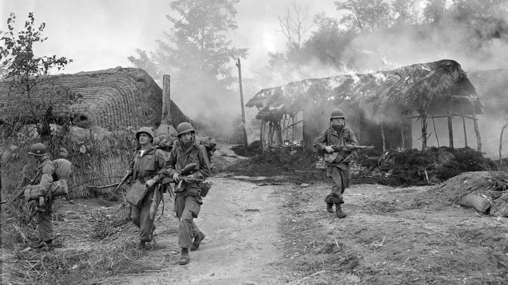 U.S. troops move through burning shacks somewhere in Korea, Oct. 20, 1950. (AP Photo/Max Desfor)