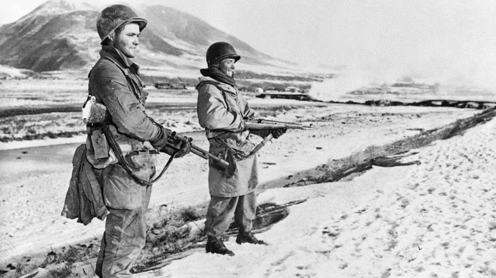 In this photo provided by the U.S. Army, with the frozen Yalu River and snowy Manchurian hills at their backs, Cpl. Mayford J. Gadner, left, of Michigan, and Pfc. Tommie Robinson from Las Cruces, N.M., stand guard near Hyensanjin on Korea's northeastern front, Dec. 2, 1950. The GIs are members of the U.S. Seventh Division. (AP Photo)