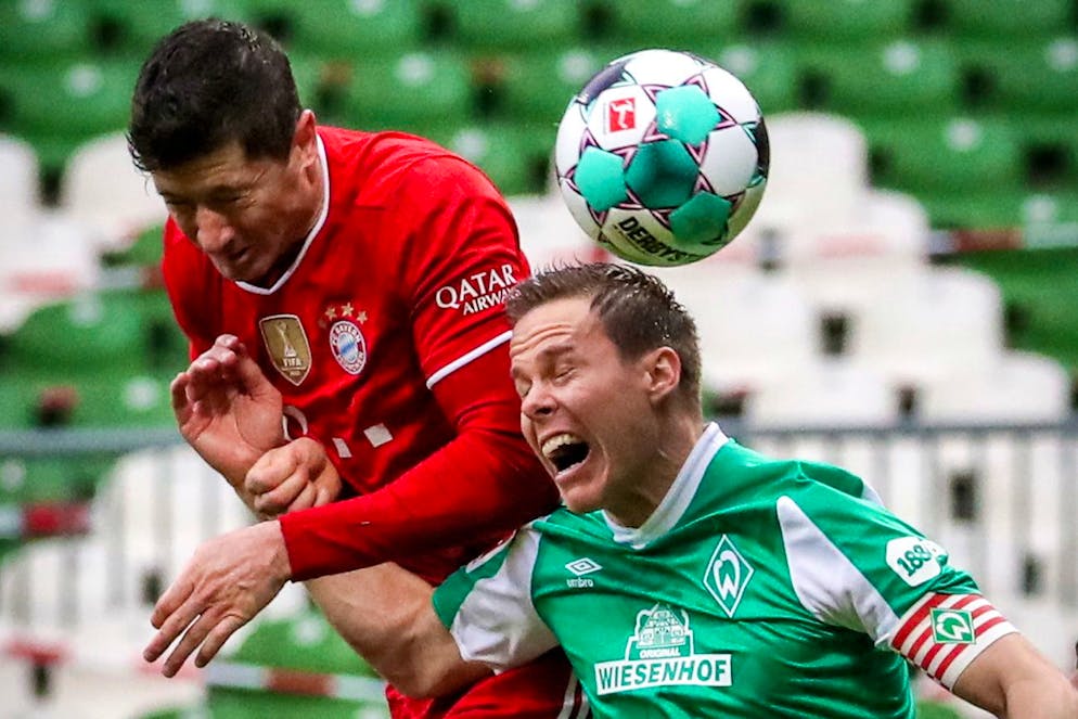 epa09072230 Bayern's Robert Lewandowski (L) in action against Bremen's Niklas Moisander (R) during the German Bundesliga soccer match between Werder Bremen and Bayern Muenchen in Bremen, Germany, 13 March 2021. EPA/FOCKE STRANGMANN / POOL CONDITIONS - ATTENTION: The DFL regulations prohibit any use of photographs as image sequences and/or quasi-video.
