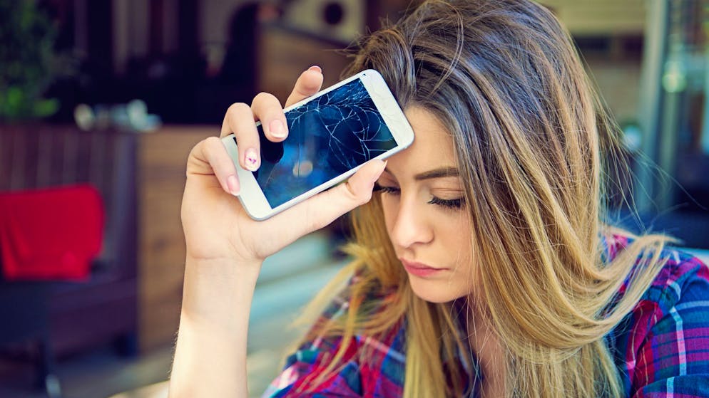 Young girl is devastated after her mobile phone is fall down.