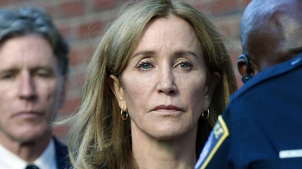 Felicity Huffman leaves federal court with her brother Moore Huffman Jr. following, after she was sentenced in a nationwide college admissions bribery scandal, Friday, Sept. 13, 2019, in Boston. (AP Photo/Michael Dwyer)